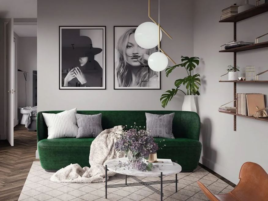 Серый интерьер гостиной оживляет уютный зеленый диван